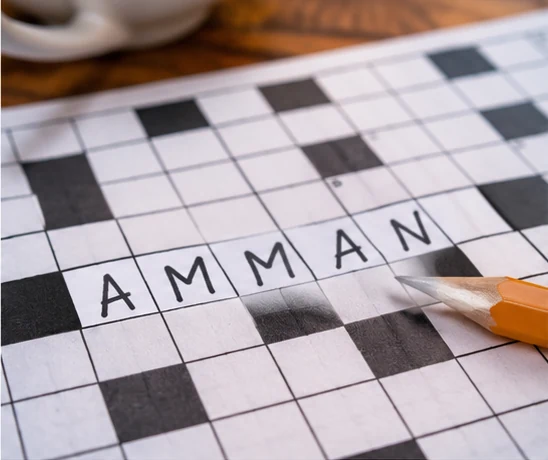Krzyżówka z odpowiedzią AMMAN – elegancka fotografia kartki z diagramem i ołówkiem